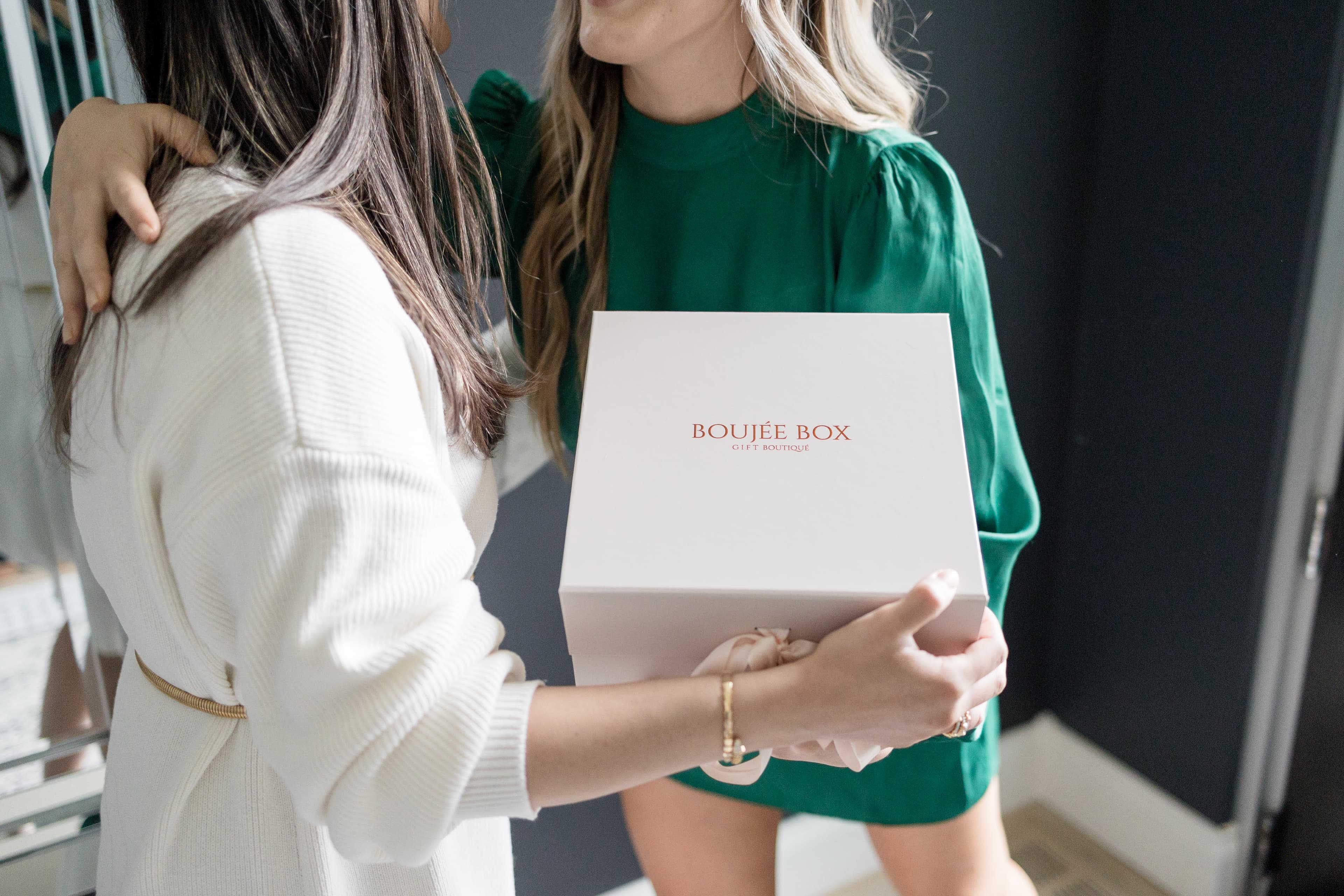 Friends opening a Boujée Box gift box